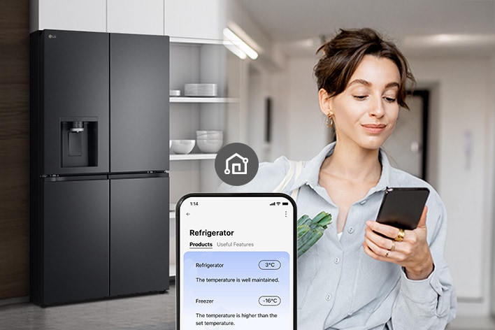 Woman checking refrigerator temperature remotely on her smartphone.