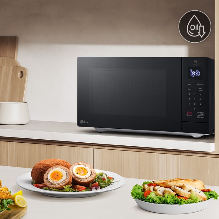 The image shows that a variety of foods are on the kitchen table, and roasted chicken is being cooked by neochef microwave oven.