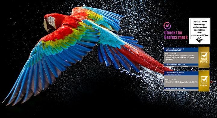 Colourful parrot in ultra-high definition against a black background. Water drops are suspended in the air all around it. The image showcases Perfect Colour as each different hue on the parrot's body is vibrant and vivid. Different logo certifications from UL and Intertek are visible. These refer to its 100% Colour Fidelity, 100% Colour Volume claim. Text is also visible, check the Perfect Colour certification mark.