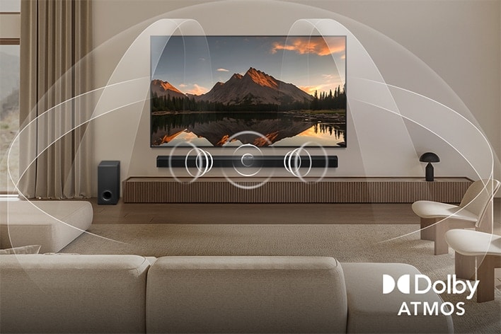 Dimly lit, cozy living room with an OLED LG TV with LG Soundbar. On the screen is a close-up of an electric guitar being played. Graphics show how Dolby Atmos fills the whole space with surround sound from all directions. Dolby Atmos logo is at the bottom corner.