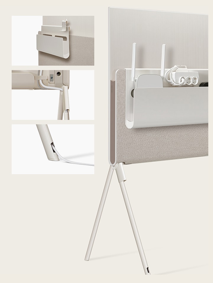LG OLED Posé’s Cable & Accessory Organiser hangs from the Media Shelf. LG OLED Posé’s detachable cable holder is seen closeup on the base of the TV. LG OLED Posé’s cable is seen closeup running out of the TV leg. LG OLED Posé is seen from the back with the Cable & Accessory Organiser holding a router, outlet, and device.