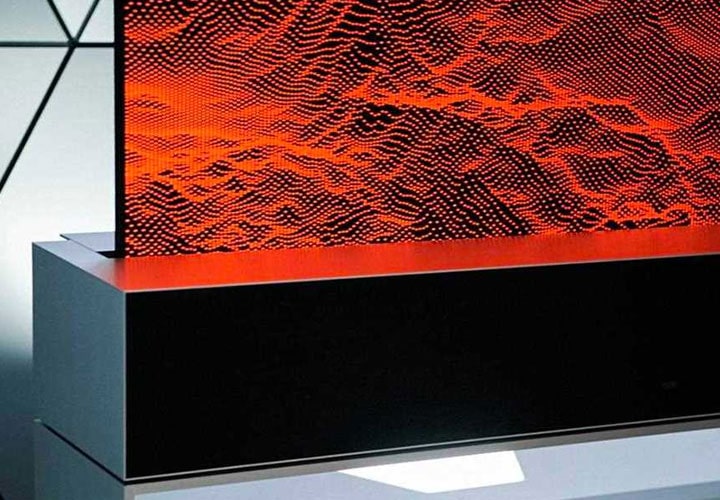 The LG SIGNATURE Rollable OLED TV rolls into its base.