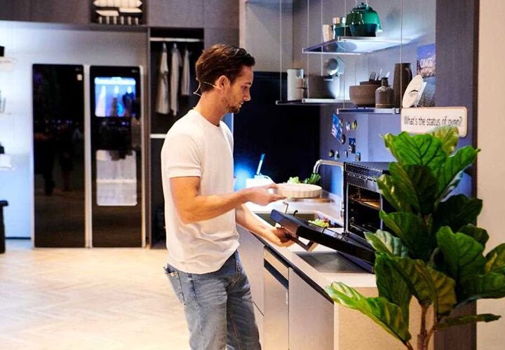 IFA 2018: a demonstrator puts a pizza into the LG NeoChef microwave oven, in the kitchen of the travel zone