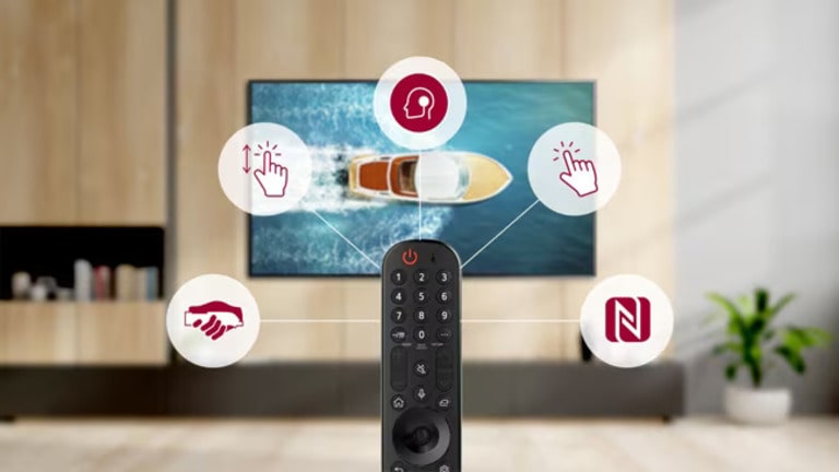 LG Magic Remote in a modern living room with a TV showing a boat. The remote features gesture control, voice recognition, point-and-click, and NFC