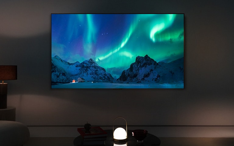 LG OLED TV on the wall of a dimly lit living room