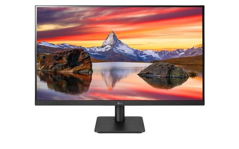 A sleek LG monitor displaying a stunning landscape featuring a vibrant sunset, a serene lake, rocky formations, and a snow-capped mountain in the background. The monitor has a slim bezel and a sturdy black stand