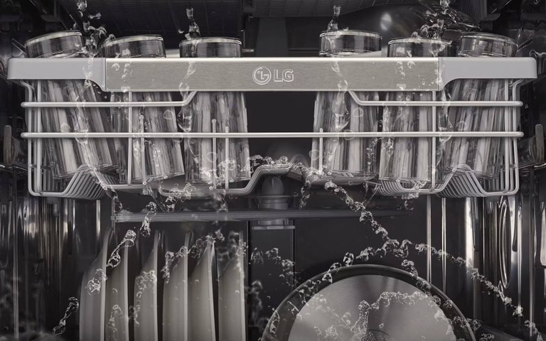 Inside view of an LG dishwasher, with water jets spraying over glassware and plates, demonstrating the powerful cleaning performance of the appliance.