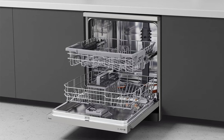 An open LG ThinQ dishwasher integrated into a modern kitchen with dark cabinetry, showcasing spacious racks and a stainless steel interior