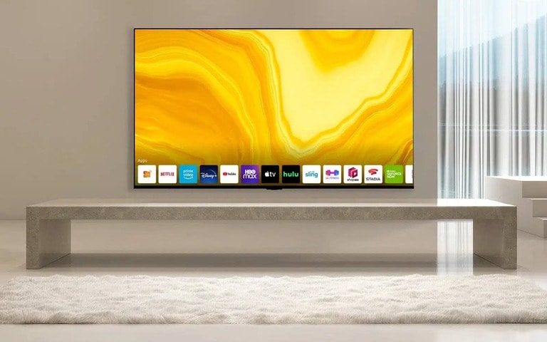 A minimalist modern living room featuring a sleek LG TV on a stone console, with bright yellow art displayed on the screen. The clean, elegant design emphasises both style and functionality.