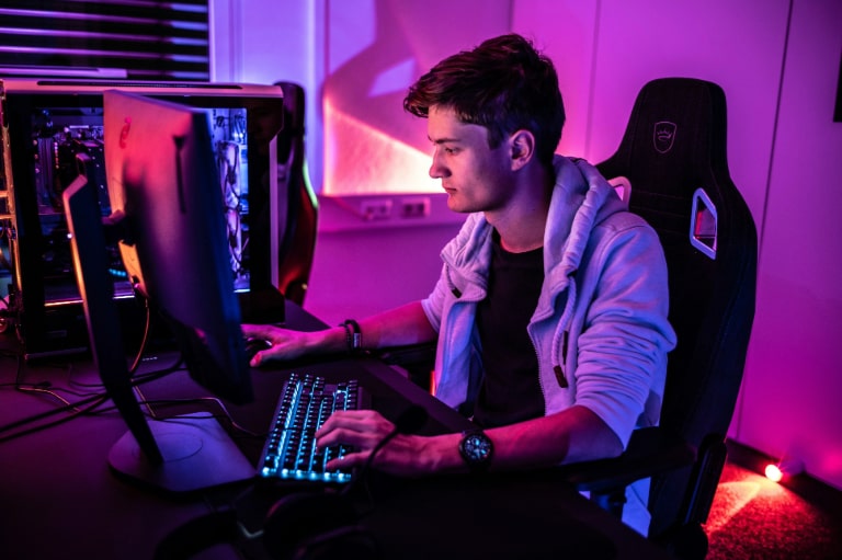 A man cave with an immersive gaming setup, including a high-quality gaming monitor, creating an intense visual experience in a personal, cosy space