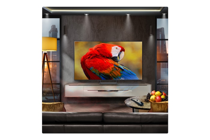 A family sits on a couch facing a LG QNED TV sitting above a TV stand with a little girl pointing to a screen depicting two dolphins. The title talks about how you can enjoy high resolution on a massive screen.