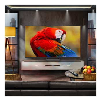 A family sits on a couch facing a LG QNED TV sitting above a TV stand with a little girl pointing to a screen depicting two dolphins. The title talks about how you can enjoy high resolution on a massive screen.