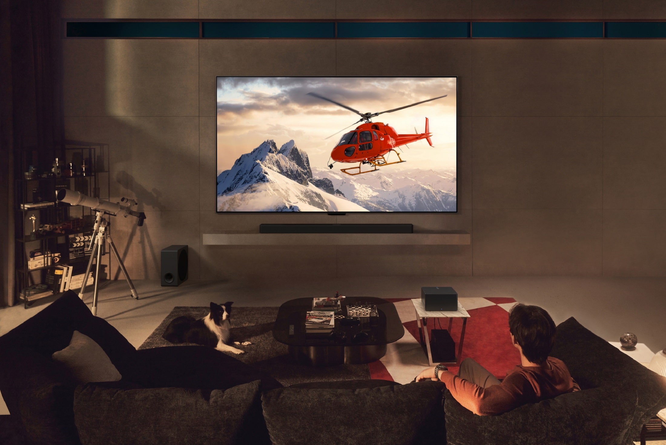 LG OLED TV with a helipcotper on the screen in a dark living room