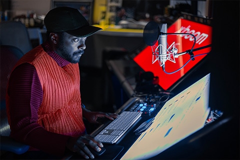 will.i.am is producing music at his desk