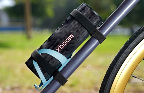 xboom Grab is placed on a bicycle's water bottle holder.