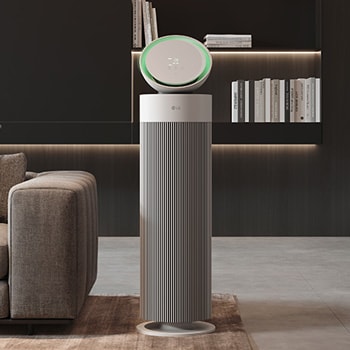 LG air purifier placed in a modern living room with a city view and minimalist furniture