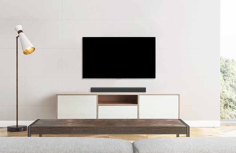 A TV and a soundbar placed in a plain living room.