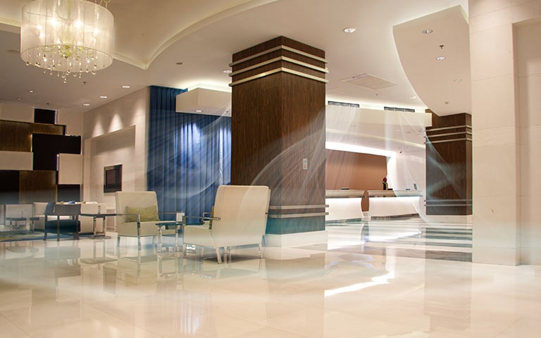 An image of a spacious hotel lobby with air conditioning on.