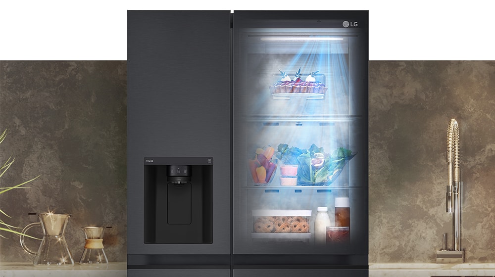 LG side-by-side refrigerator with ice dispenser on left door and illuminated shelves with food items on right.