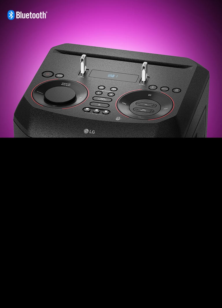 A closeup view of controls on top of LG XBOOM, with two USBs plugged in. A Bluetooth logo is shown in the upper left corner.