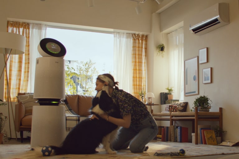 Woman playing with dog in the living room