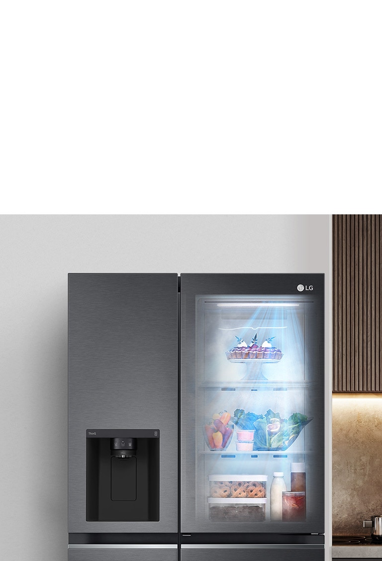 The front view of a black InstaView refrigerator with the light on inside. The contents of the refrigerator can be seen through the InstaView door. Blue rays of light shine down over the contents from the DoorCooling function.