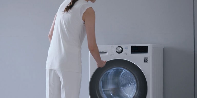 Woman standing in front of a LG dryer