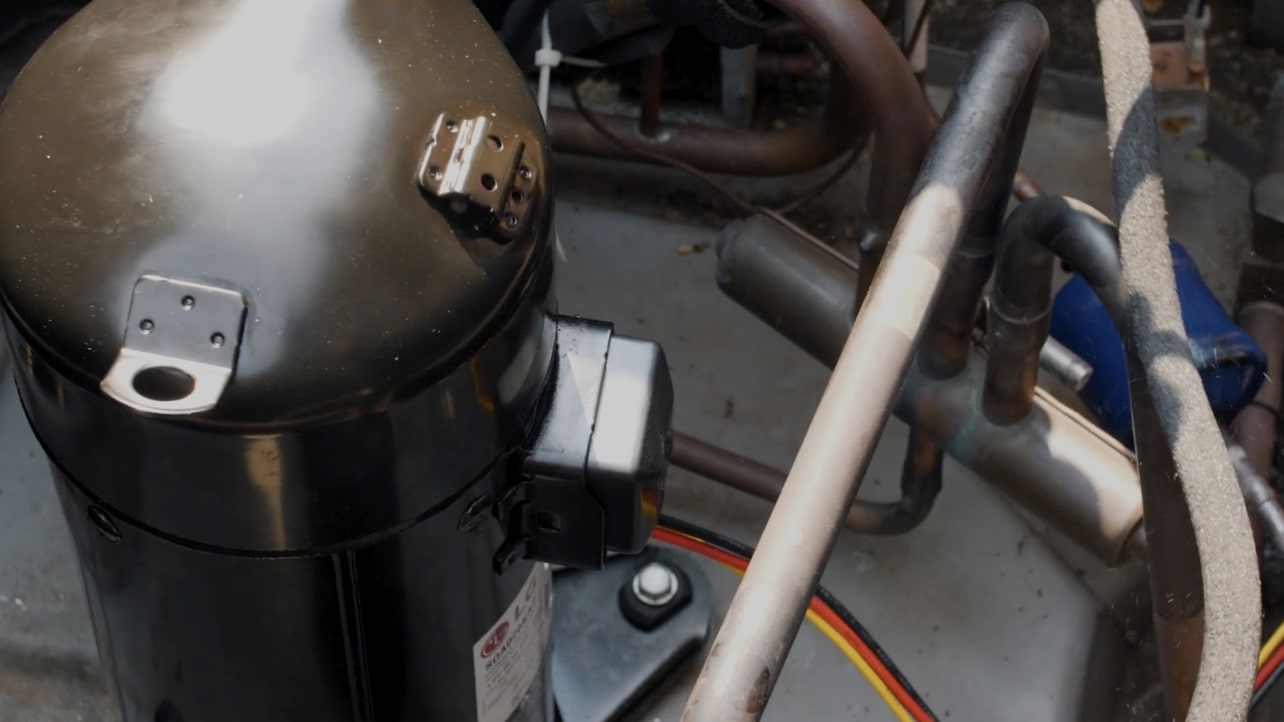 Holding a checklist and writing something to check the condition of the compressor.