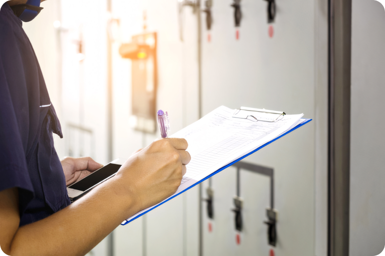 Holding a checklist and writing something to check the condition of the compressor.