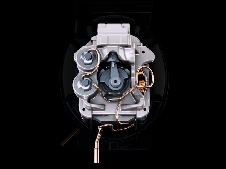 Top view of an LG variable speed reciprocating compressor's internal mechanism within a metallic housing on a dark background.