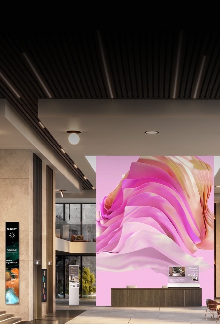 Various digital signage displays in a corporate lobby welcoming visitors with an elegant atmosphere and informative content.