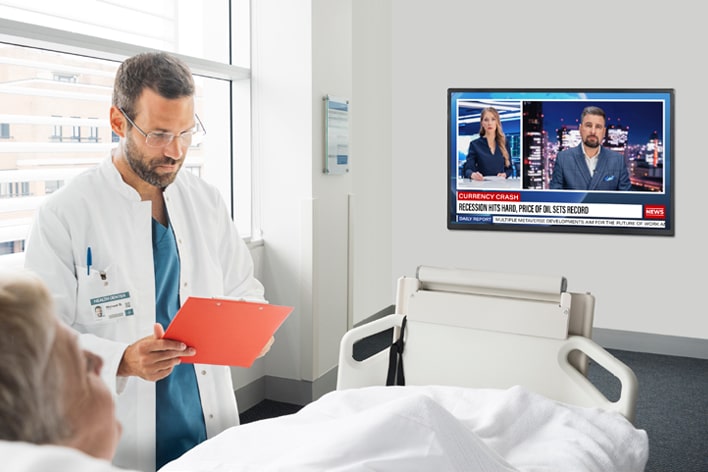 An LG commercial TV is installed in a hospital room.