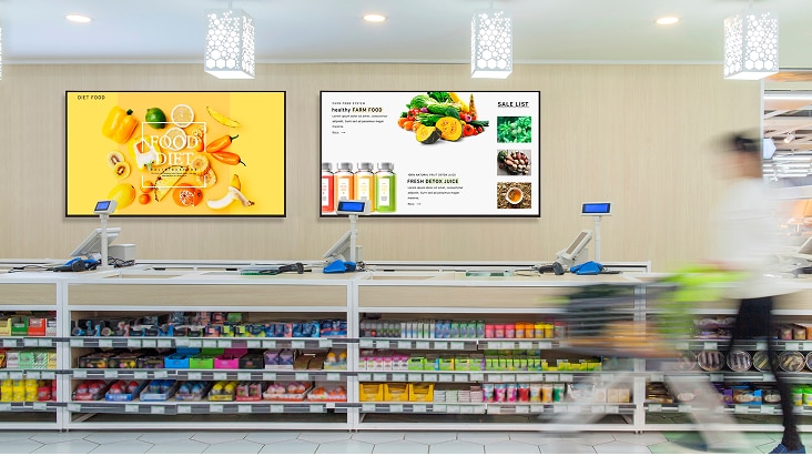 LG UHD Digital Signage installed in a convenience store, displaying food and beverage promotions.