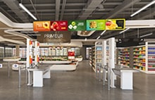 LG digital signage in a supermarket displaying colourful product categories. LG retail display solutions designed to improve shopper navigation and promotional campaigns.