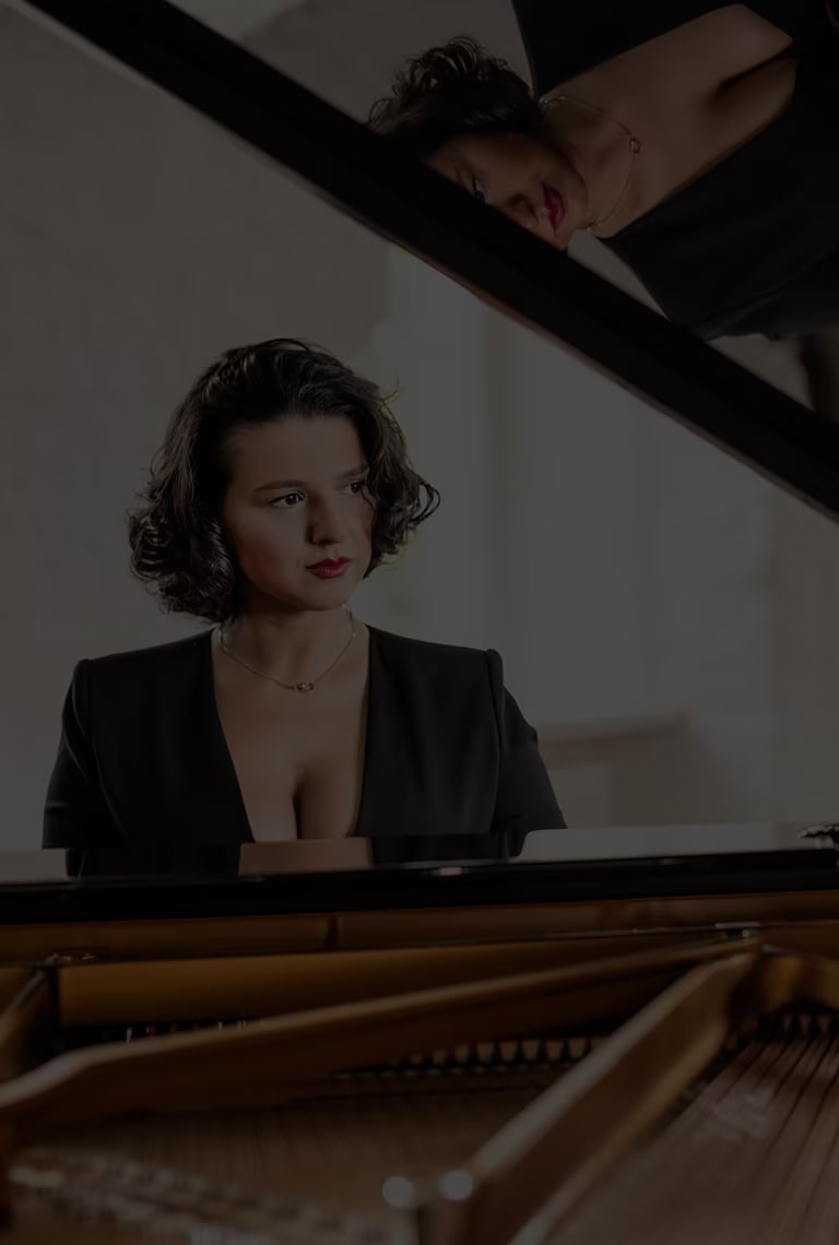 Khatia Buniatishvili is sitting at a piano.