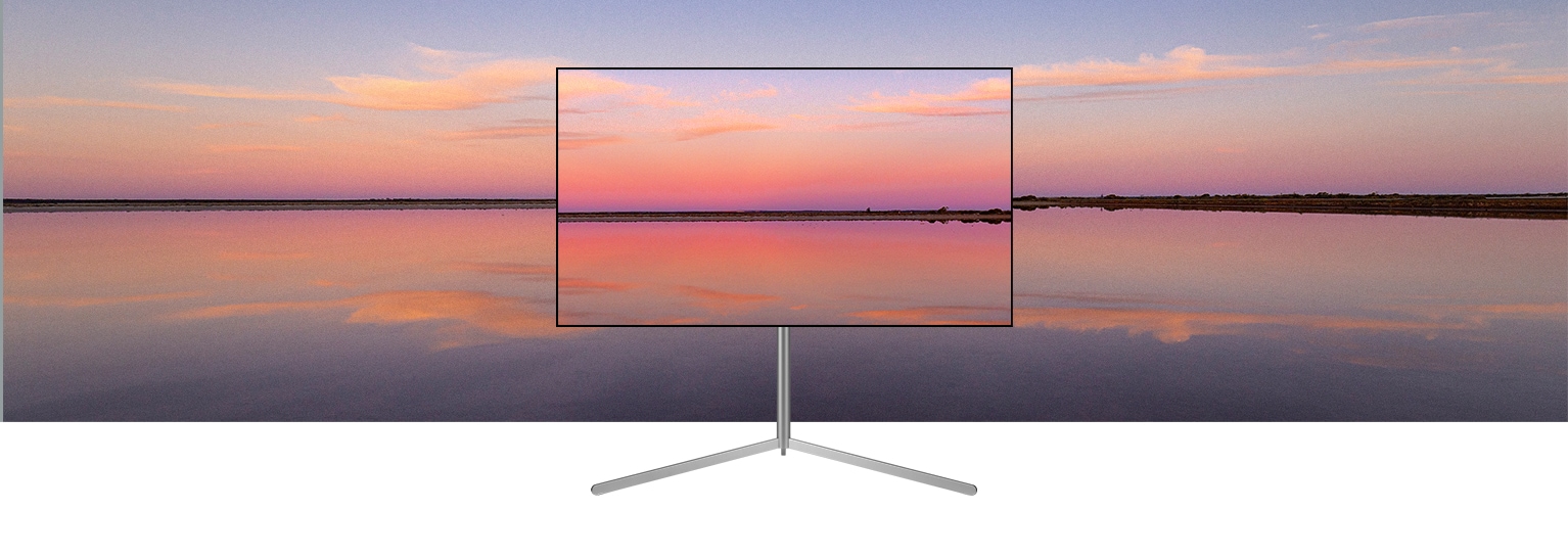 Un televisor LG OLED en un soporte Gallery muestra una puesta de sol azul y rosa que se funde con el fondo