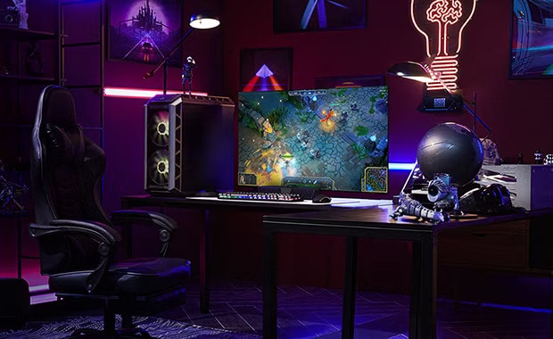 A man plays a game on the smallest LG OLED television while sitting at a desk