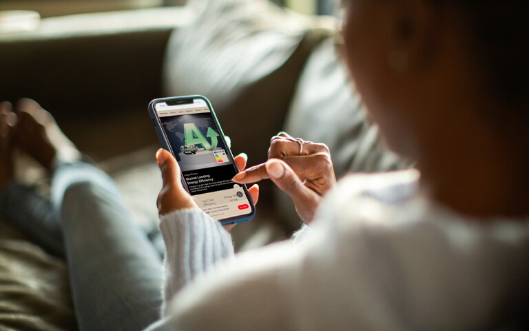 Younger consumer who cares about the environment researching sustainable initiatives for sustainable companies