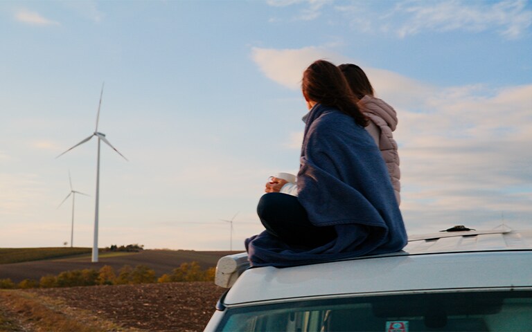 young consumer in a field with wind turbines