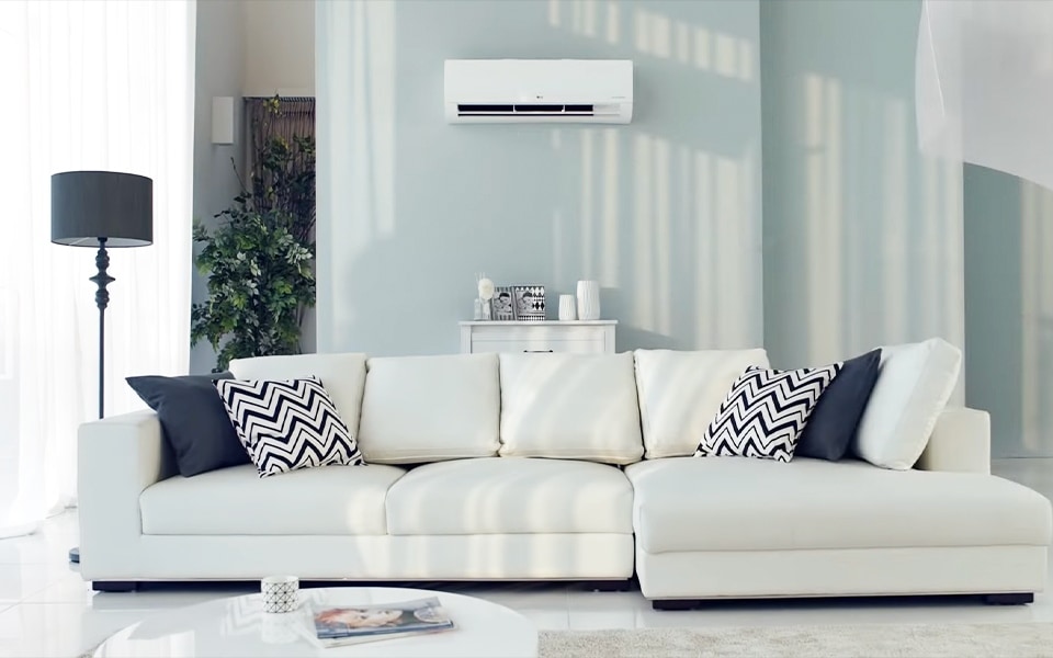 A small air conditioner cools a large living room.