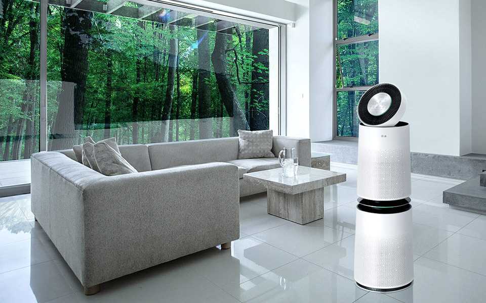 An LG air purifier placed in the middle of a living room