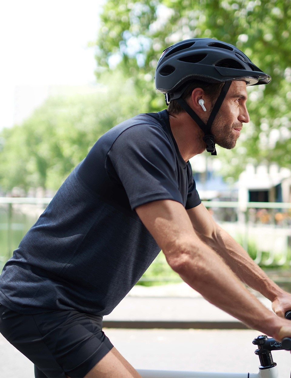 A man cycles using sound earbuds