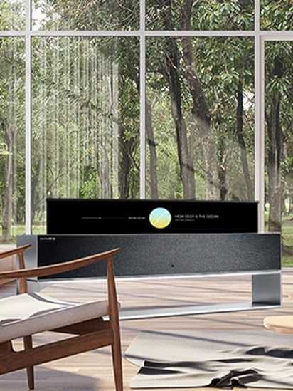 A wide view of the living room with LG SIGNATURE Rollable OLED TV in line view.