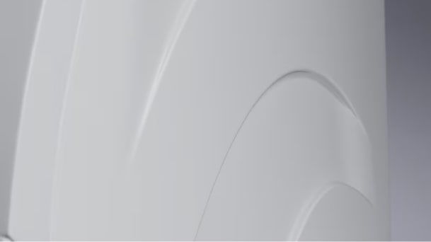 A close up image of the white enamel body of the LG Signature Washing Machine, showing the details in the material.