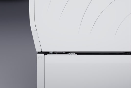 Image showing the top right section of the LG Signature Washing Machine. Part of the machine door, Quick Circle Display panel, and detailed white enamel body are shown.