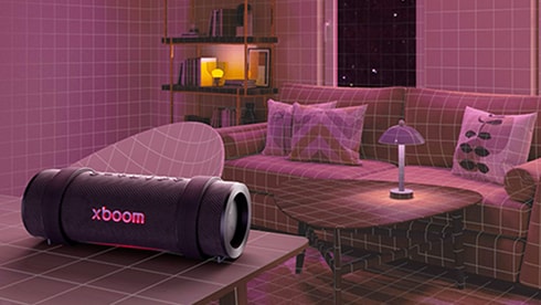 The LG xboom is placed on a living room table surrounded by furniture.