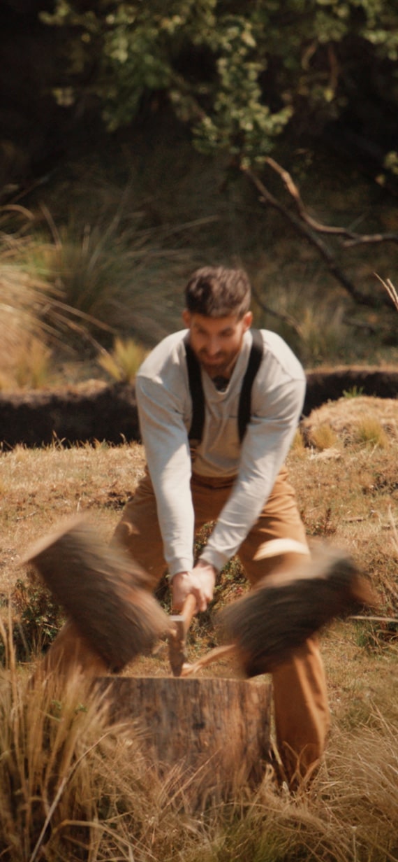 A man splitting wood with an axe.