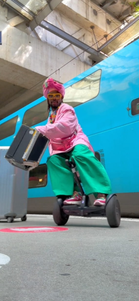 A man dynamically posing on a Segway.