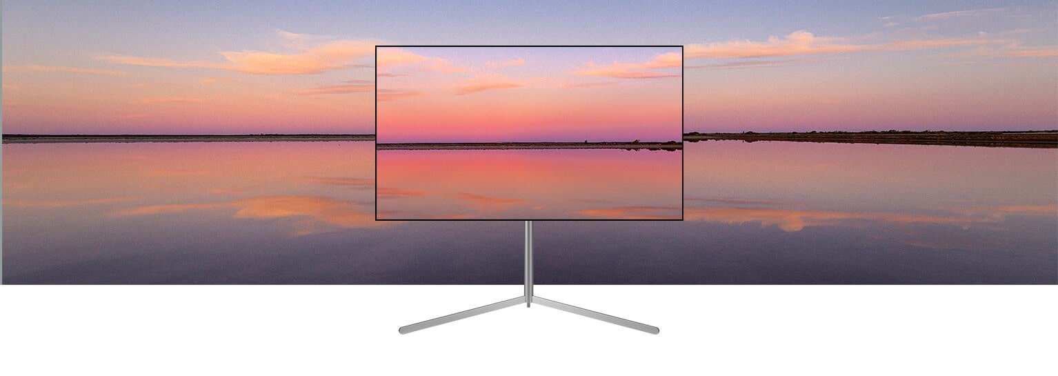 Un televisore LG OLED su supporto Gallery mostra un tramonto sui toni del blu e del rosa che si fonde con lo sfondo