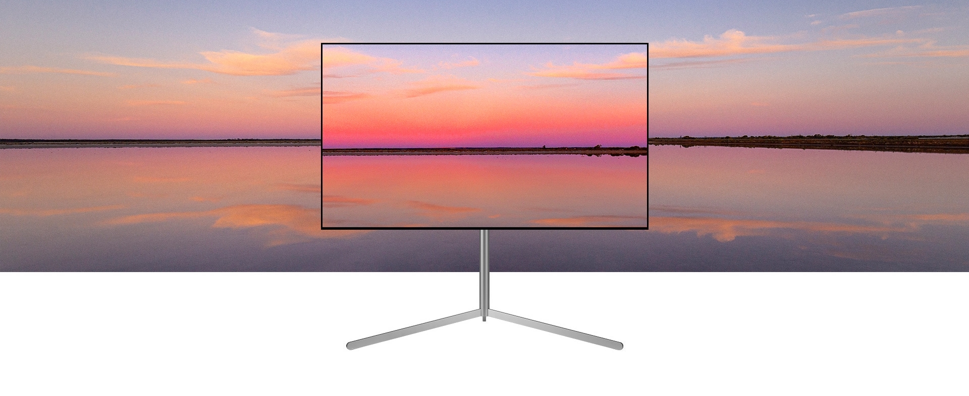 Uma TV LG OLED sobre um Gallery Stand mostra um pôr do sol azul e rosa que se mistura com o fundo.